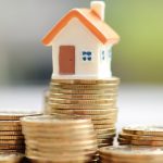 Photo of mini house on coins